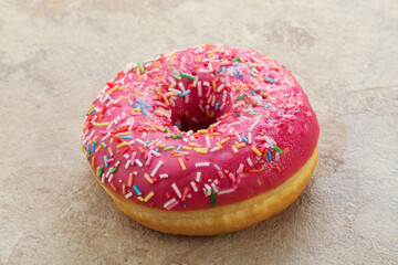 Sweet glazed struwberry donut with icing