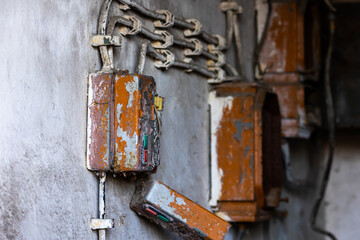 Old electrical cabinet with safety fuses and switches. Picture taken in soft, natural light.