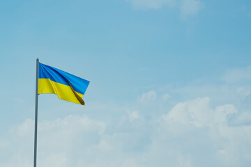 Ukraine flag on the blue sky . 3d rendering.