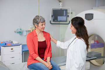 We have your scan results. Shot of a mature woman being comforted by a doctor before and MRI scan.