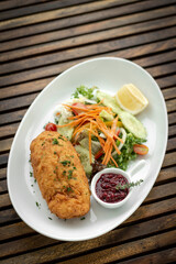 chicken cordon bleu meal with salad in french restaurant