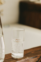 transparent glass with water on a wooden tray in the bathroom