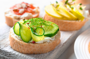 Sandwich with feta, cucumber and dill on a light background.