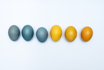 Six Easter eggs in Ukrainian patriotic yellow and blue colors on a white background, for peace