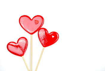 Fototapeta na wymiar Lollipops hearts on white background. Congratulations, space for text.