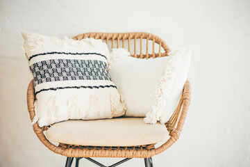 Details of modern boho, bohemian, scandinavian style. Pillow at the chair.