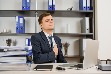 man workaholic has a heart attack at work in his office after an overwork. .