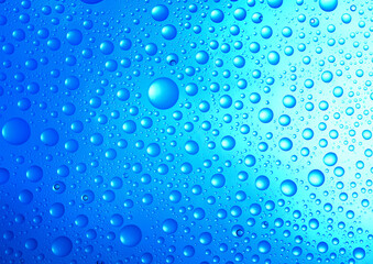  water drops over blue background.close up