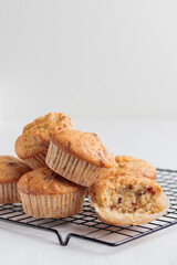 Vanilla fresh baked muffins on a white table with nuts and berries