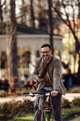 Fototapeta na wymiar A man riding a bicycle through the park, on a bicycle path.