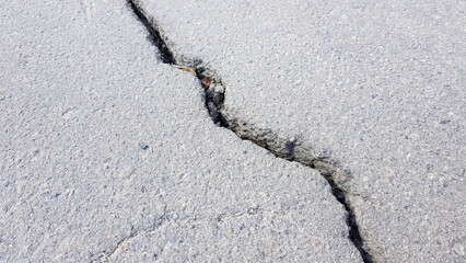 Closeup road made of old asphalt with crack in sunny day