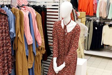 Female mannequin in summer dress. Clothing store, department with clothes for women