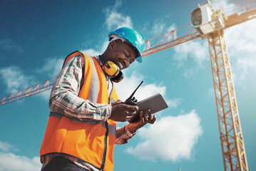 New age tech for new age construction. Shot of a young man using a digital tablet while working at...