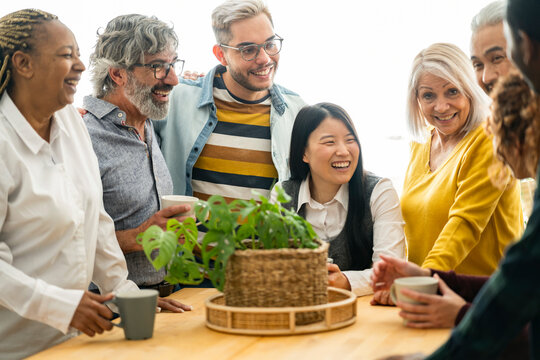 group of people of different ages in the kitchen, multiracial people - focus on young man with glasses -