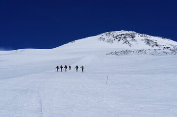 Fototapeta na wymiar Group of hikers climbing in snow mountain Elbrus