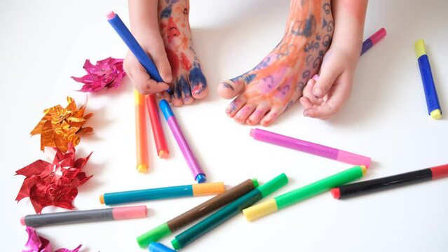 Funny cute bare feet. Child painting coloring feet