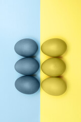 Blue and yellow Easter eggs on a background from the flag of Ukraine, for peace, no war, patriotism