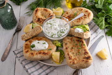 Homemade pan bread with yogurt, herb-garlic dip