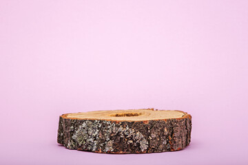 authentic natural wooden podium on pink background, eco scene for presentation of cosmetic products