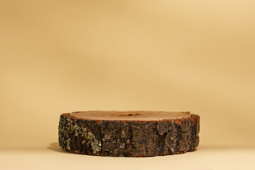authentic natural wooden podium on beige background, eco scene for presentation of cosmetic products, copy space