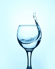 Clear water in a glass, delicious spring transparent with a splash in the glass