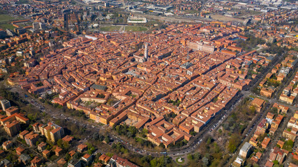 Aerial view on the historic center of Modena surrounded by tree-lined avenues. In the center stands the Ghirlandina tower.