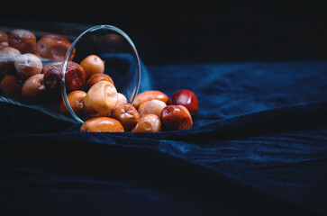Dried fruits in a glass. Scattered dried fruits. Healthy eating. - obrazy, fototapety, plakaty