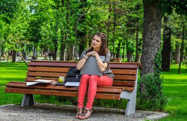 Young Woman with a Laptop in the Park