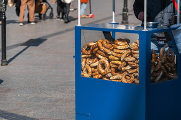 Polish street food - Polish bagels in Krakow, round pretzels with poppy seeds and cumin behind the...