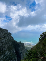 View of the ocean down a valley off Table Mountain, Cape Town, on a cloudy day