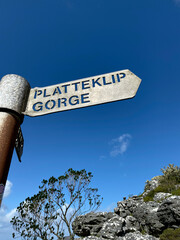 Hiking trail signs on Table Mountain, Cape Town, on a cloudy day.