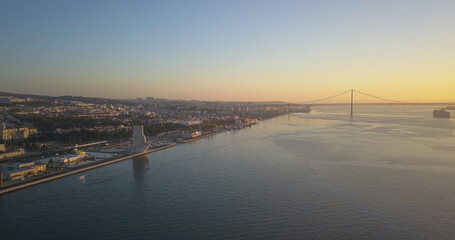 Fototapeta premium Alfama with pattern of discoveries in front and bridge 25 April at background