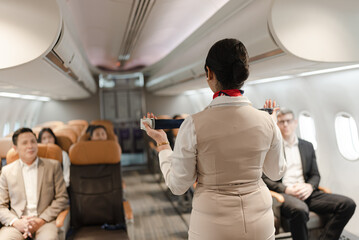 Air hostess, operator explaining passengers how to use seat belt in the plane 