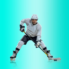 Fototapeta na wymiar Professional ice hockey player hitting puck for winning goal in action on gradient multicolored neon background. Concept of sport competition.