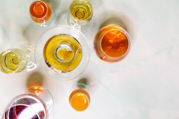 Filled cocktail glasses from the top on a light background