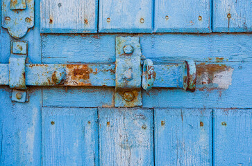 door lock for key closing, keyhole, hasp bolt. Collection of old vintage retro locks on the textured colored door. Close-up