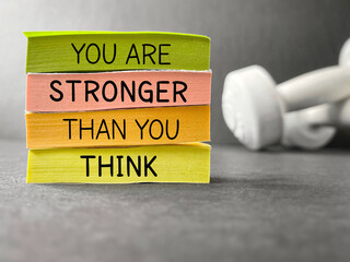 Inspirational and motivational quote concept. You are stronger than you think text on notepaper...