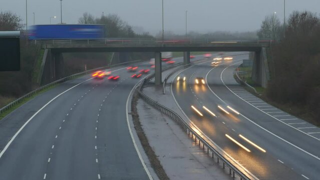Trails of light on a motorway. Time lapse traffic in the evening