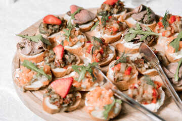 Decorated catering banquet table with different food appetizers assortment on a party