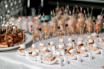 Decorated catering banquet table with different food appetizers assortment on a party