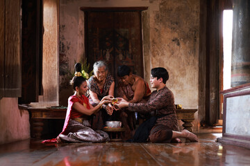 Songkran festival traditional culture in Thailand , Younger Pouring scented water on the hands of reserved elders and ask for blessing at Choengthar temple.