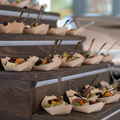 Decorated catering banquet table with different food appetizers assortment on a party