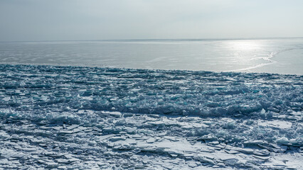 Baikal lake at winter and big block of ice near coast