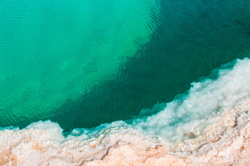 Natural Salt water lake in desert. Oasis in Siwa, Egypt. Tourism spot in Egypt. Closeup turquoise water and white salt