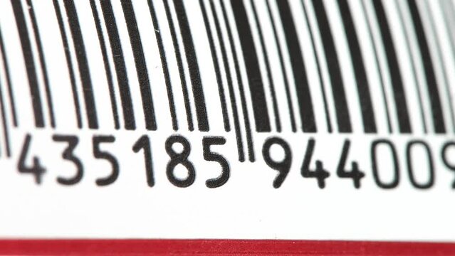 Part of a barcode on a simple drink tin can, bar code tag label object rolling in, detail, macro, extreme closeup, nobody. Food products, origin, retail business and consumerism abstract concept