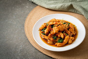stir-fried fried fish with basil and chili in thai style
