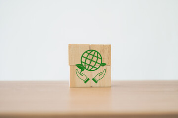 green globe icon on cube ,CSR, eco green sustainable living, zero waste, plastic free, earth day, world environment day, responsible consumption Social responsibility core value concept