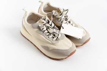 modern sneakers made of combined materials and colors with a high sole and a label with copy space....
