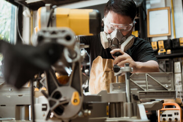 Carpenter cutting wooden with a miter saw or circular saw in shop, woodworking repair and construction tool concept ,selective focus