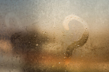 Autumn rain, the inscription on the sweaty glass - question mark